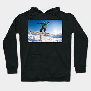 Snowboarder sliding on a rail Hoodie